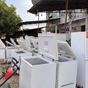 Refrigerators and chest freezers in an open-air appliance market