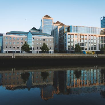 Mixed-use buildings on the Dublin waterfront reflected in the water