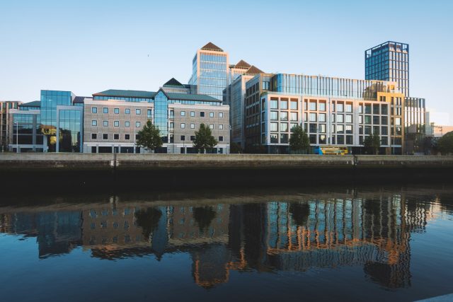 Mixed-use buildings on the Dublin waterfront reflected in the water