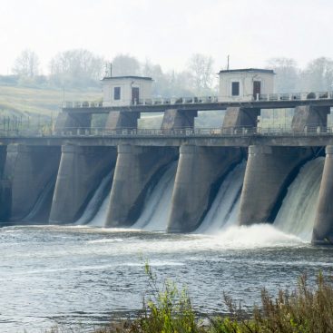 A hydropower dam with water released through the spillways