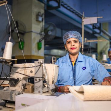 A worker at a textile machine in an Indian factory